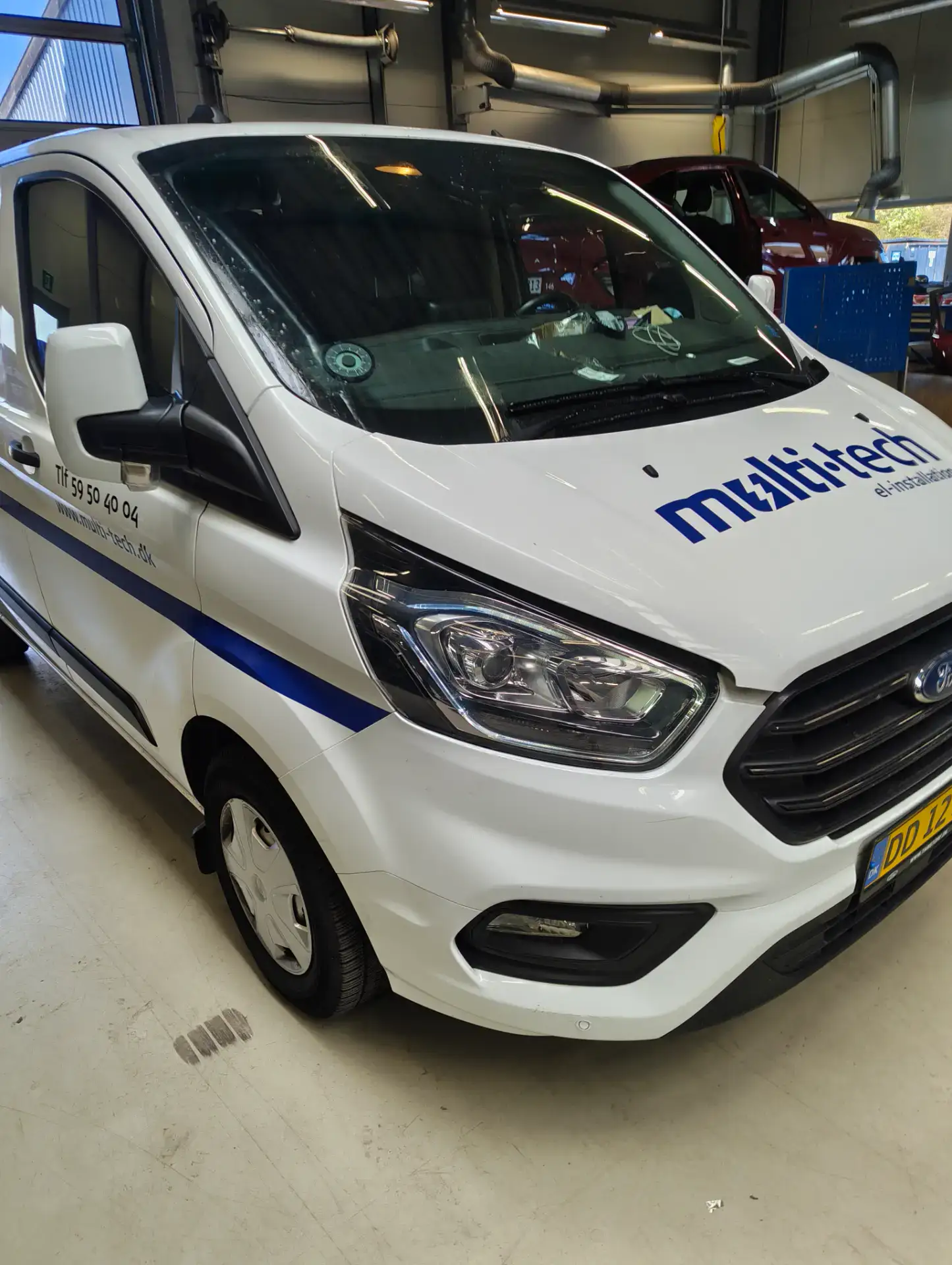 Professionel autoglasreparation af Ford Transit i værkstedet.